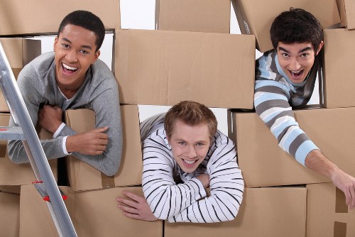 Moving team transporting office equipment during local removals in Feltham