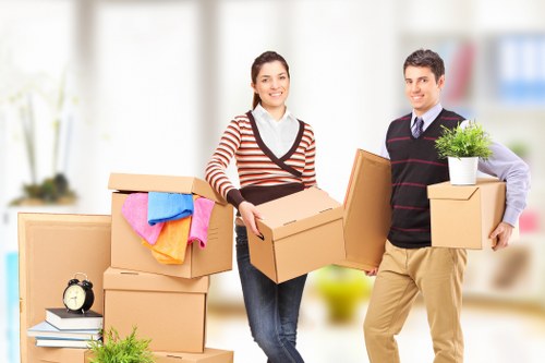 Professional movers handling boxes and furniture in Feltham