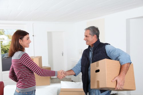 Professional movers packing household items for a local move
