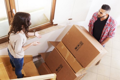 People moving boxes into short-term storage in Feltham