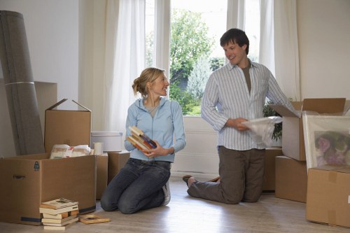 Packed moving boxes and furniture ready for removals in Feltham