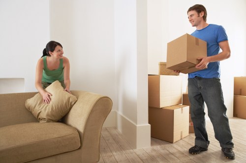 Organized furniture storage facility in Feltham with boxes and sofas